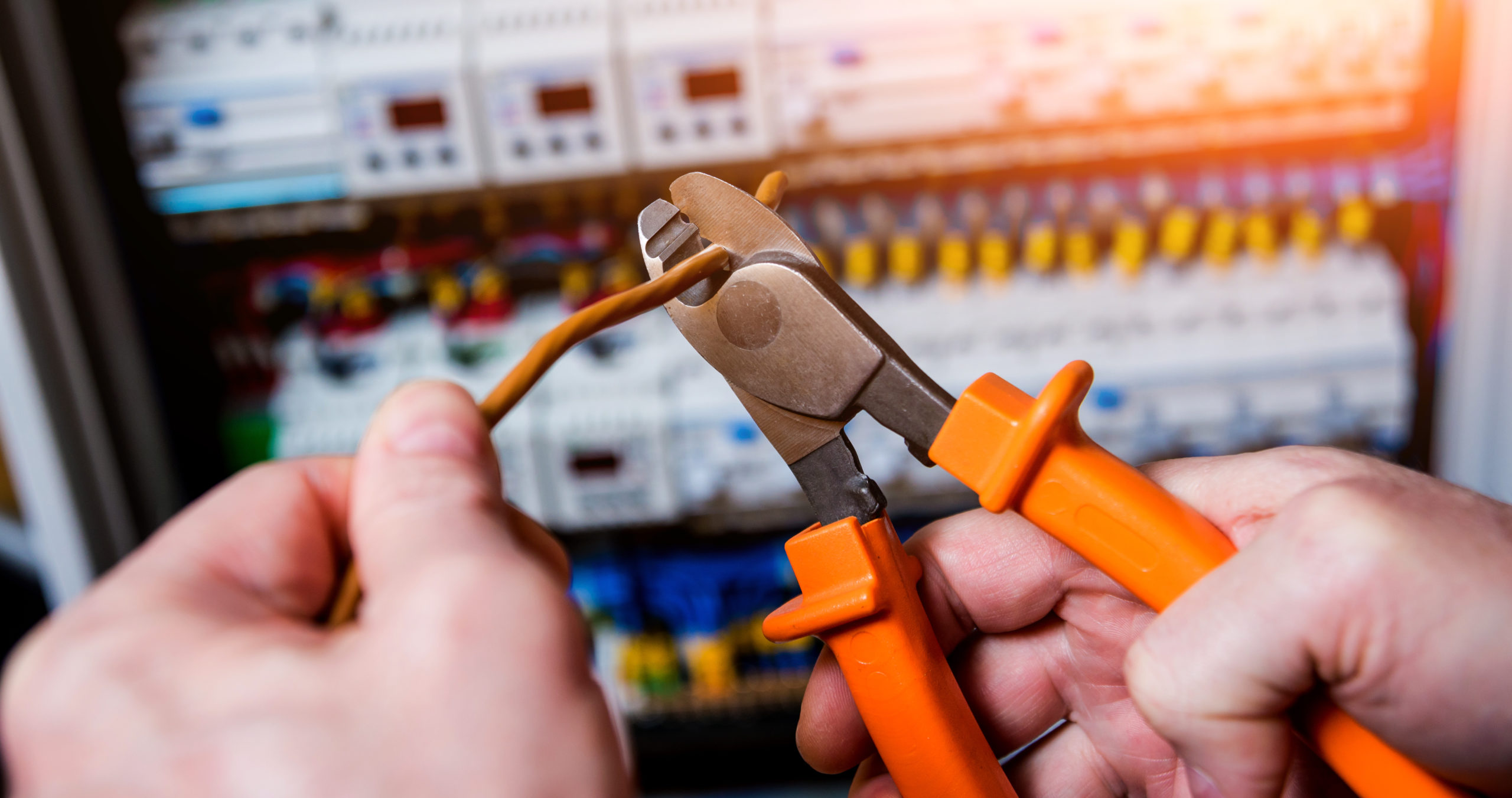 The man is repairing the switchboard voltage with automatic switches. Electrical background